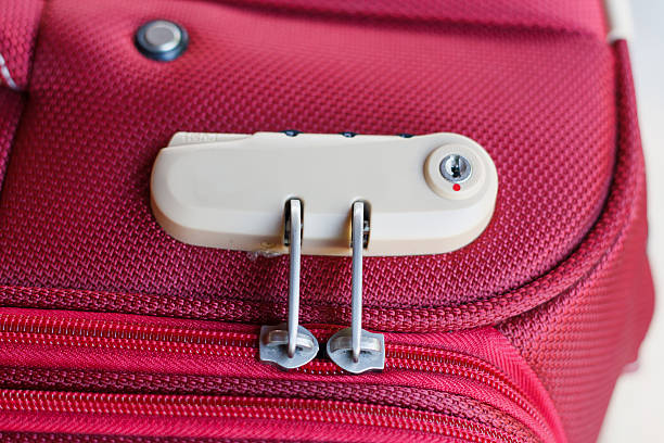 combination lock on red suitcase travel bag